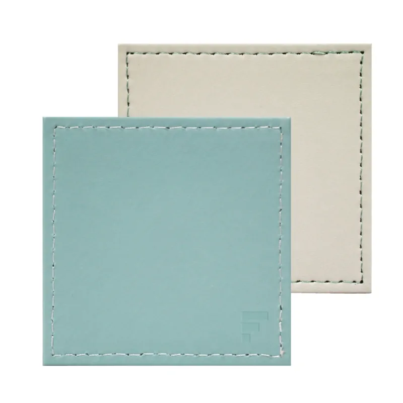 Set of four Freeform Untersetzer in mint and elfenbein colors, ceramic coasters with a sleek, modern design.